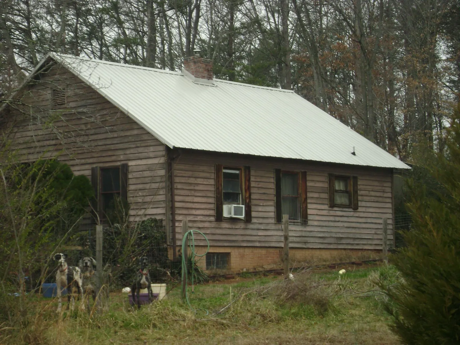 White metal roof on an old wood sided farmhouse, from a Metal Roof Installation job in Alcove